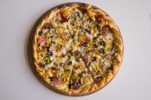 pizza topped with mozzarella, olives, mushrooms, and peppers