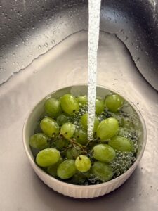 fresh grapes being washed